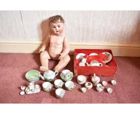 Four 19th century and later child's tea sets, comprising a thirteen piece part tea set with gilt detailing, an eight piece pa