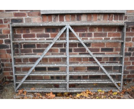 Two galvanised five bar farm gates, height 114cm, width 180cm.PROVENANCE: The Raymond Rush Collection. Mr Rush was an enginee