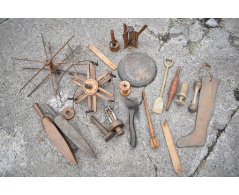 A collection of 19th century and later treen tools and implements, including two wool winders, a folding wool winder, two sur