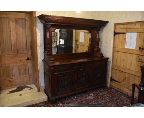 A Victorian carved walnut mirror back sideboard, with dentil cornice above two fluted and carved columns over two drawers and