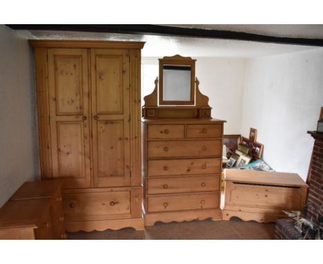 A modern pine wardrobe, with two doors above a base drawer on bracket feet, height 194cm, width 111cm, depth 60cm, also a pin