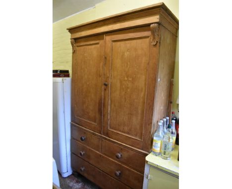 A Victorian pine housekeeper's cupboard, with two panelled cupboard doors enclosing shelves above two short and two long draw