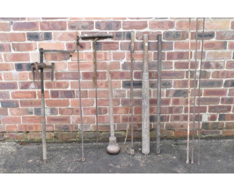 A collection of ten vintage iron and treen tools including a punner, a large crowbar, bail puller, an adjustable three prong 