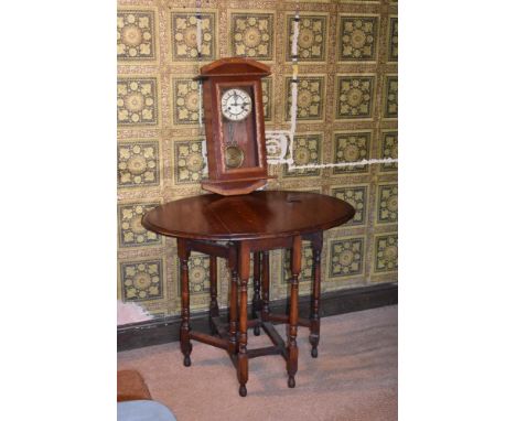 An oak gate leg table, height 72cm, with a Gustav Becker wall clock (2)PROVENANCE: The Raymond Rush Collection. Mr Rush was a
