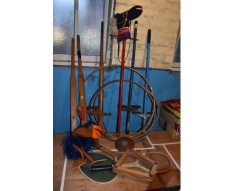 Three vintage children's pogo sticks, Nicoltoys stilts, three hula hoops, two tennis rackets and a hobby horse.PROVENANCE: Th