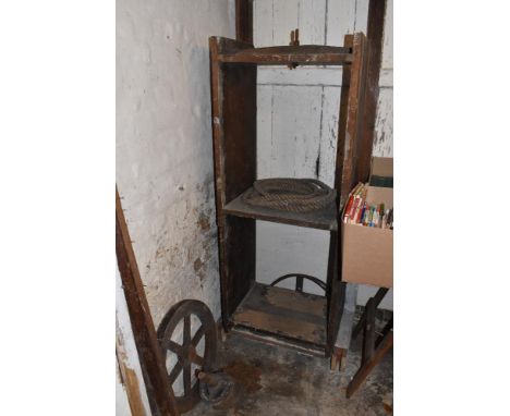 A 19th century cheese lift, with two shelves, cast iron pulley wheel, and other mechanism parts, height 169cm (attention need