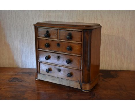 A late Victorian mahogany miniature apprentice chest, with two short and three long drawers, on disc feet, height 33cm, width