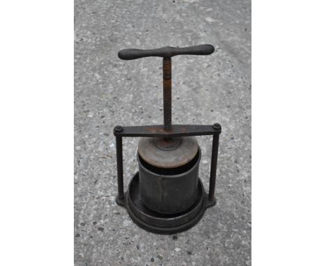 A vintage iron and tin cheese/fruit press, of circular form, height with handle up 49cm.PROVENANCE: The Raymond Rush Collecti