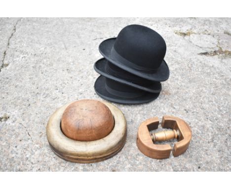 A vintage treen bowler hat maker's mould, in two sections, the underside of the centre section numbered 344 and also 718, als