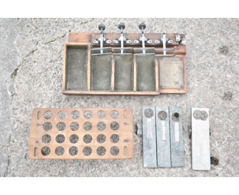 The RBK egg grader with five sections and stained pine base, length 46cm, with an egg rack and two metal egg scales / graders