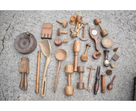 A collection of 19th century and later treen items including a shovel shaped scoop, wormed, a treen ladle, a clamp, a four pr