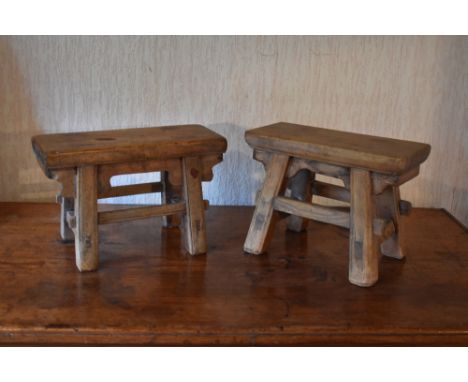 A near pair of Chinese hardwood stools, with rectangular tops on moulded legs, height 12cm, length 30.5cm, width 13.5cm.PROVE