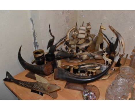 An assortment of bovine horn items including five beakers of varying size, a model boat, various animal models, etc.PROVENANC