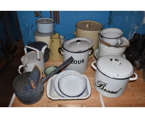 A collection of vintage enamelled kitchen and country house items including a cream and green enamelled bread bin, height 32c