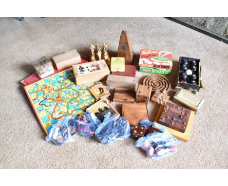 A collection of vintage and modern treen and other toys and games, including Snakes and Ladders boards, carpet bowls, puzzles