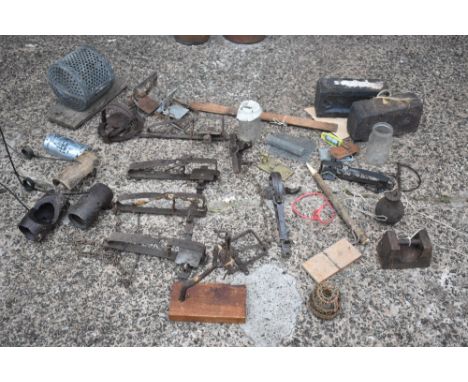 An assortment of vintage animal and mole traps, of varying styles, including a circular galvanised trap. Some of the traps in