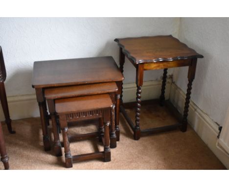 An oak nest of three tables, on turned legs, largest height 54cm, also an Edwardian oak occasional table with serpentine top,