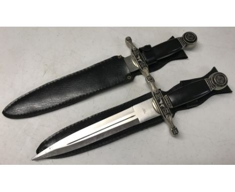 2 modern replica daggers in sheaths. With Celtic design to cross guard and pommel. Approx. 38cm long.