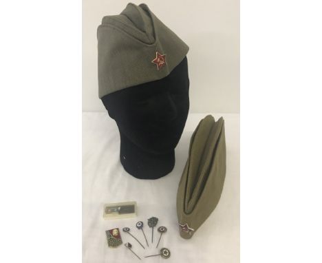 2 Soviet Russian army side caps together with a collection of Soviet pin badges.  