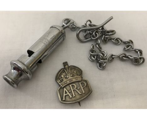 A WWII pattern Home Front A.R.P whistle on chain together with a hallmarked silver lapel badge.  