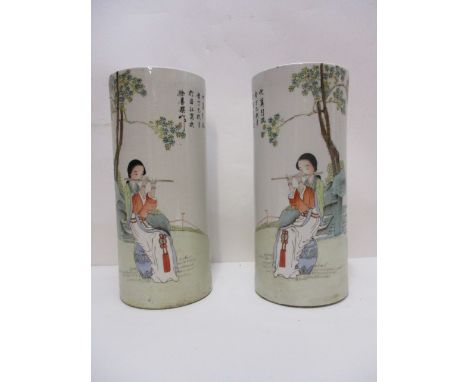 A pair of early 20th century Chinese porcelain vases of cylindrical form, decorated with a woman playing a musical instrument