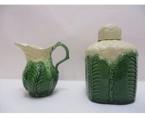 An 18th/19th century pottery cauliflower and leaf moulded tea caddy of lobed form with a domed over, decorated in cream and g