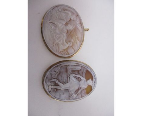 Two cameo brooches, one carved with a group of two women and a child, the other a full length portrait of a woman, each set i