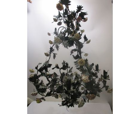 An Italian green painted metal chandelier with six scrolled branches decorated with applied leaves and ceramic flowers, 26 sp