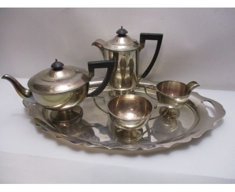 A four piece silver tea service by Walker & Hall, Sheffield 1933, comprising a teapot, a hot water pot, a sugar basin and a m