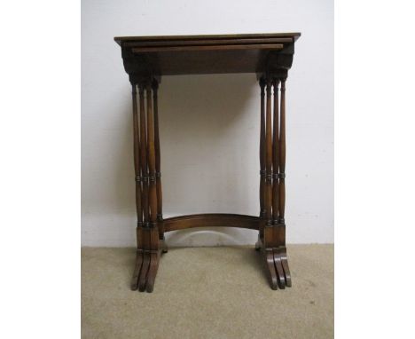 A nesting set of three early 20th century mahogany occasional tables, with a bead edge over slender, ring turned, baluster co