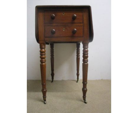 An early Victorian mahogany work table having twin fall flaps over two end drawers with facsimiles to the reverse, raised on 