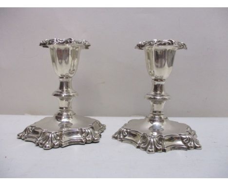 A pair of Edward VII silver dwarf candlesticks by Martin, Hall & Co, Sheffield 1902 with detachable, embossed sconces and kno
