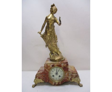 A late 19th century French, gilt metal and mottled brown, marble cased mantle clock having a woman holding a flower on a step