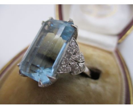 A white gold, emerald cut aquamarine and diamond dress ring, total weight 5.57g