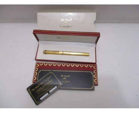A Les Must De Cartier Vendome ribbed Cisele Trinity ring, gold plated cased ballpoint pen with certificate, cards and paperwo