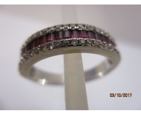 An 18ct white gold, three row diamond and ruby claw set, half eternity style ring, 4.7g