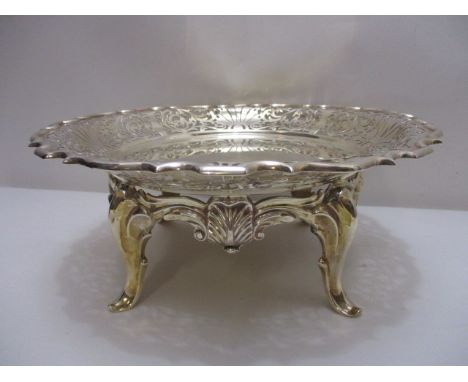 An early 20th century silver cake stand by Walker & Hall, Sheffield 1911, with a Chippendale, pierced and scrolled border ove