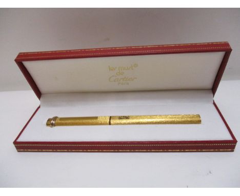 A Les Must De Cartier Vendome textured Cisele Trinity ring, gold plated cased ballpoint pen, inscribed Gulf Air, boxed