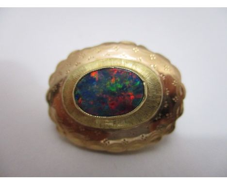 A yellow metal brooch with a central opal within a broad setting, 3.8g