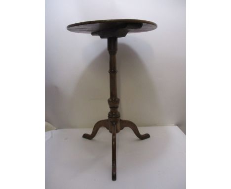 An early 19th century fruitwood and mahogany pedestal table having a ring turned column, raised on a tripod base, 27 1/2 x 17