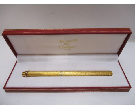 A Les Must De Cartier Vendome textured Cisele Trinity ring, gold plated cased ballpoint pen, boxed