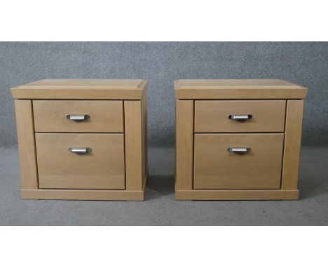A pair of contemporary light teak bedside chests. H.56 W.62 D.41cm 