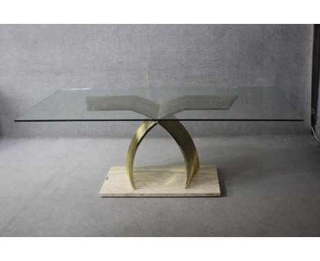 A 1970's vintage dining table with plate glass top on brass cantilever pedestal resting on a travertine marble base, designed