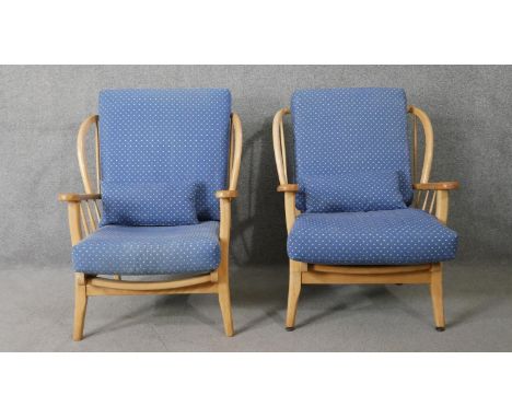 A pair of mid century vintage Ercol style light beech salon armchairs. 