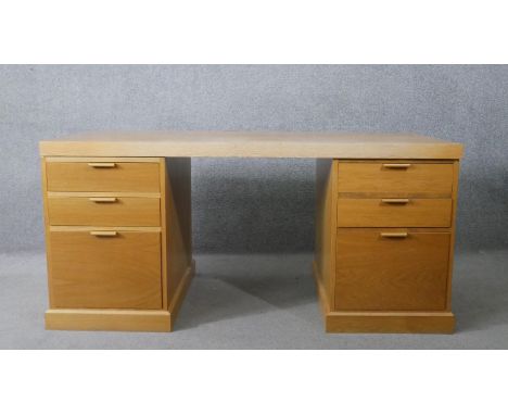 A contemporary light oak three section pedestal desk on plinth base. H.75 W.158 D.77cm 