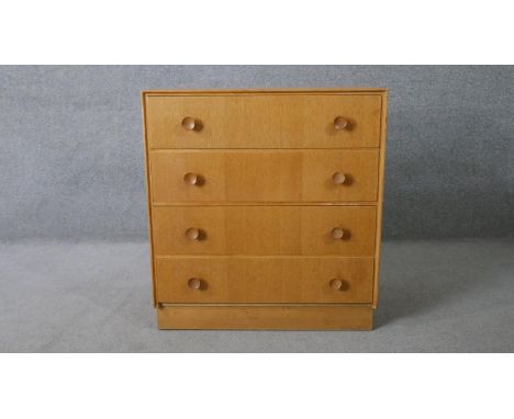 A mid century vintage light oak chest of drawers on plinth base. H.82 W.76 D.46cm 