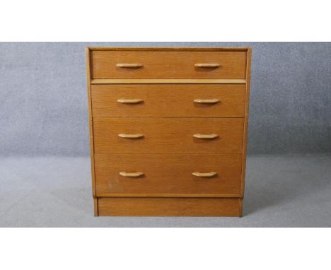 A mid century vintage light oak G-Plan chest of drawers with maker's stamp to the back. H.85 W.76 D.46cm 