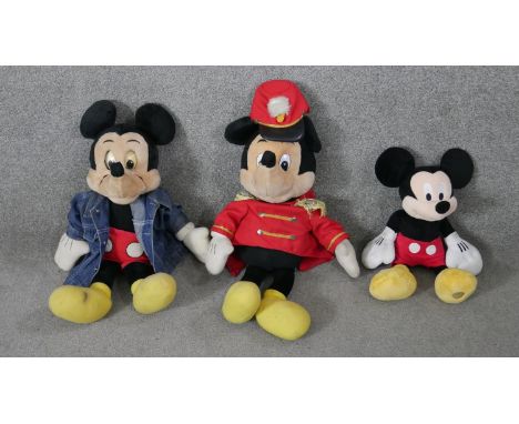 Three vintage Walt Disney Mickey Mouse toys. One 'Talking Mickey Mouse' with cassette player in the back and two others. Each