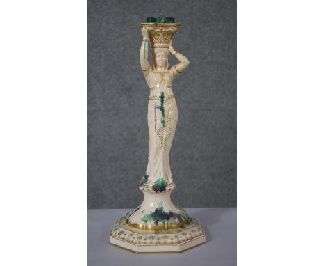 An early 20th century Sarreguemines pottery  candlestick in the form of an Arab dancer. 
H.44 W.19 D.19cm 
