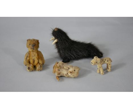 A collection of toys. Including a 1930's yellow miniature Schuco mohair bear lipstick holder, a pipe cleaner dog, a seal fur 